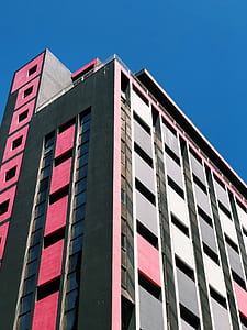 pink and gray concrete building under blue sky thumbnail