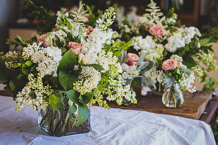 white and green bouquet of flowers in vase thumbnail