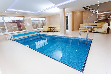 white concrete pool in room beside brown leather sofa thumbnail