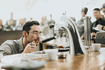 photo of man looking glass pouring espresso maker thumbnail