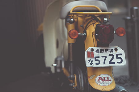 selective focus photography of yellow motor scooter thumbnail