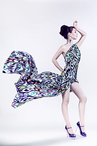 woman wearing black, green, and white one-shoulder slit dress thumbnail