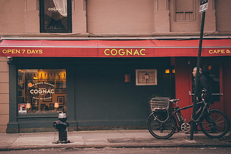 Cognac store facade with black bicycle with man thumbnail