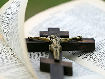 brown wooden crucifix on bible page thumbnail