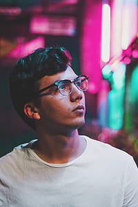 selective focus photo of man wearing white crew-neck shirt and black framed clubmaster-style eyeglasses thumbnail