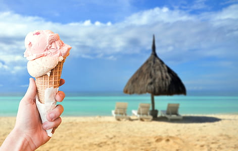 selective focus photography of person holding ice cream thumbnail