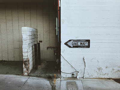 One Way arrow signage on wall thumbnail