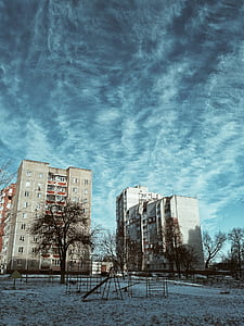 black metal playground near white concrete building during golden hour thumbnail