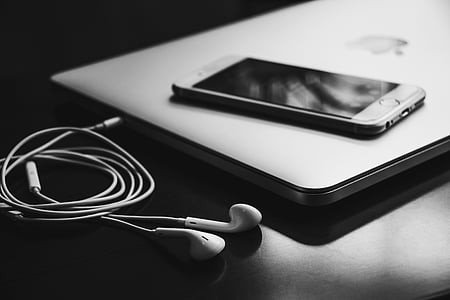 white in-ear earphones on black wooden table thumbnail