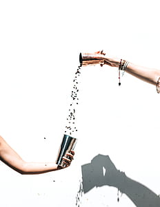 person holding stainless steel cups thumbnail