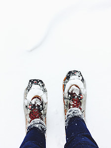 person wearing snow shoes standing on snow thumbnail