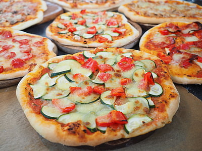 baked pizzas on brown boards at daytime thumbnail