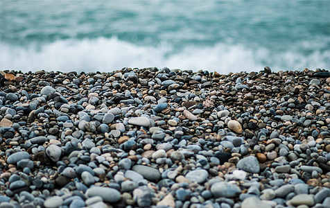 gray and black stones near body of water thumbnail