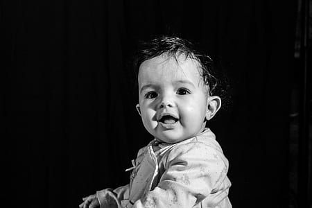 baby in white top smiling thumbnail