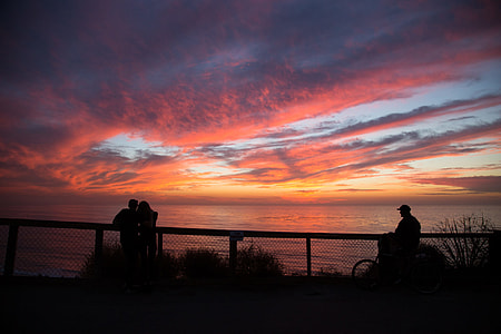 silhouette of three person standing near fence thumbnail