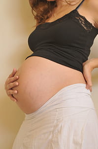 pregnant woman touching her belly thumbnail