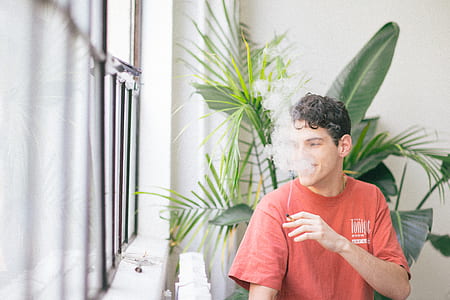 man smoking near glass window thumbnail