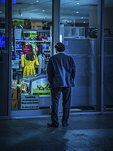 man standing outside store thumbnail