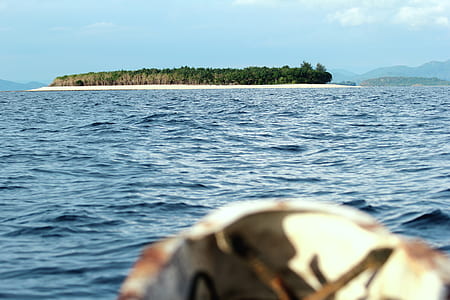 waving ocean near island at daytime thumbnail