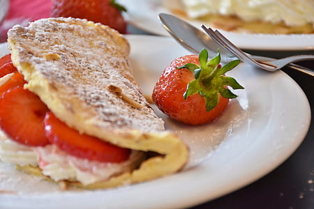 pancake beside strawberry on plate thumbnail