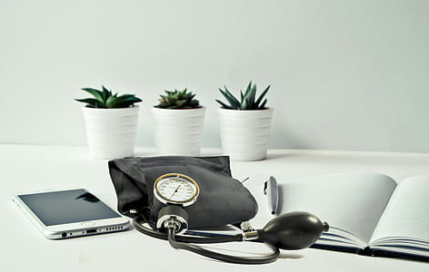 Blood pressure cuff with mobile device in office setting. Health care in doctors office. thumbnail