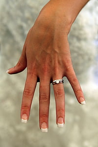 person wearing silver-colored bridal rings thumbnail