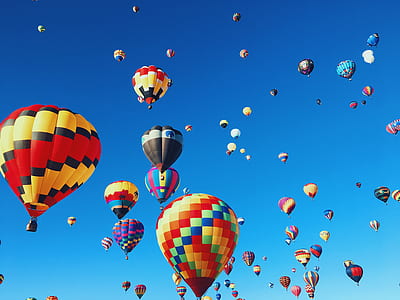 assorted-color hot air balloons under blue sky at daytime thumbnail
