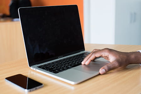 Person's Hand on Macbook Pro thumbnail