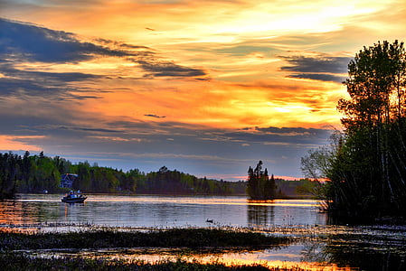 boat on body of water during sunset thumbnail