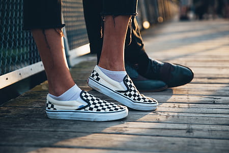 A couple s feet with focus on woman s sneakers at sunset thumbnail