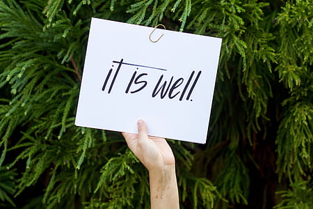 person holding white and black text board thumbnail