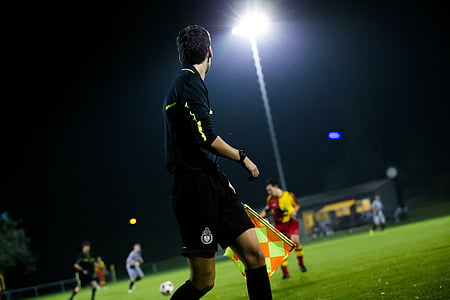selective focus photography of soccer off-side referee thumbnail