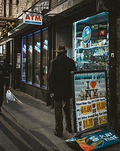 man standing outside the store thumbnail