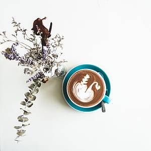 white and green ceramic teacup with cappuccino thumbnail