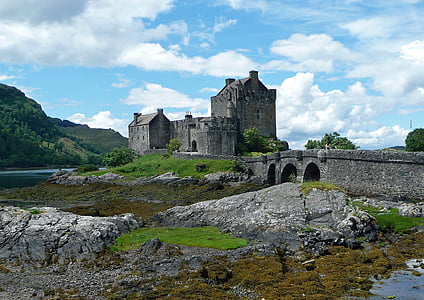 gray concrete castle near body of water with bridge thumbnail