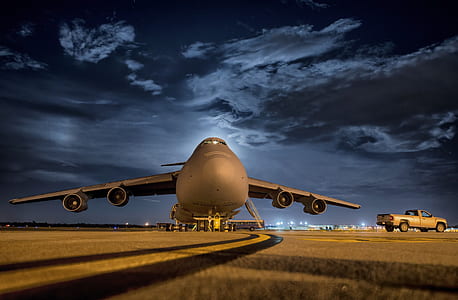 photo of airplane near pickup truck under blue sky thumbnail