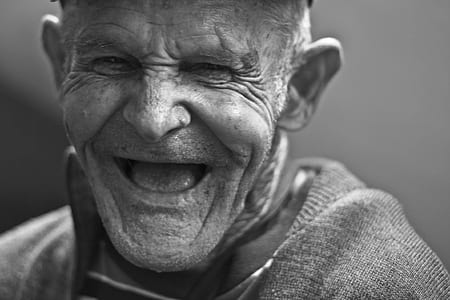 Grayscale Photo of Laughing Old Man thumbnail