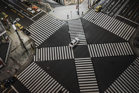 aerial photography of white car at road in intersection during daytime thumbnail