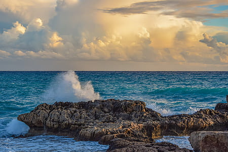 time-lapse photography of oceans waves hammering rock formation thumbnail