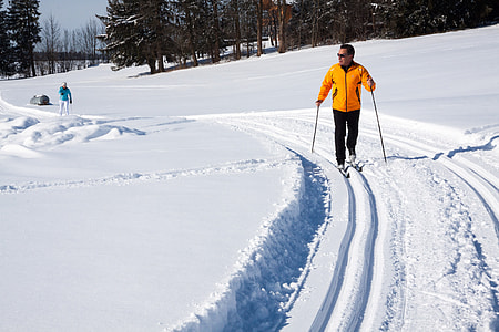 man climbing on glacier hill across woods during daytime thumbnail