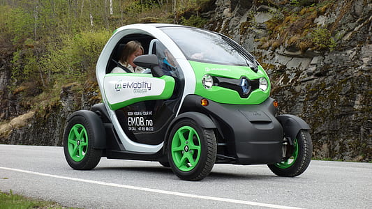 green and white Renault 3-door hatchback on gray pave road thumbnail