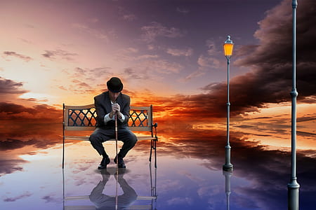 man sitting on bench while holding walking cane thumbnail