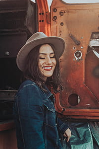 woman wearing brown hat beside truck door thumbnail