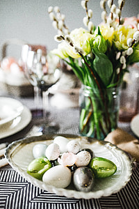Round dinner table decorated with easter motifs thumbnail
