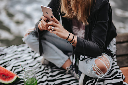 Blonde woman having a healthy snack at the wooden pier thumbnail