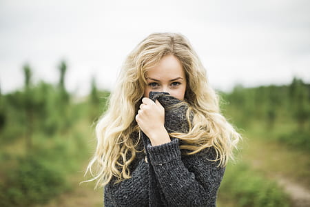 woman in black long-sleeved sweater on green grass field thumbnail