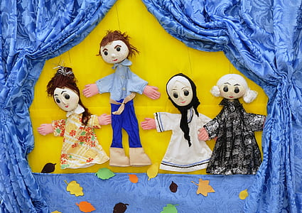 several dolls and blue curtain thumbnail