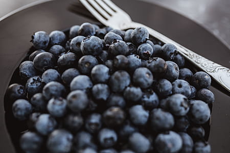 Fresh blueberries on a black plate with vintage cutlery thumbnail