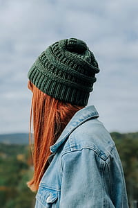 photo of woman wearing green crochet hat staring at mountain thumbnail