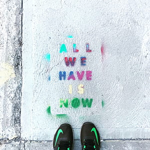 person standing on all we have now paint text thumbnail